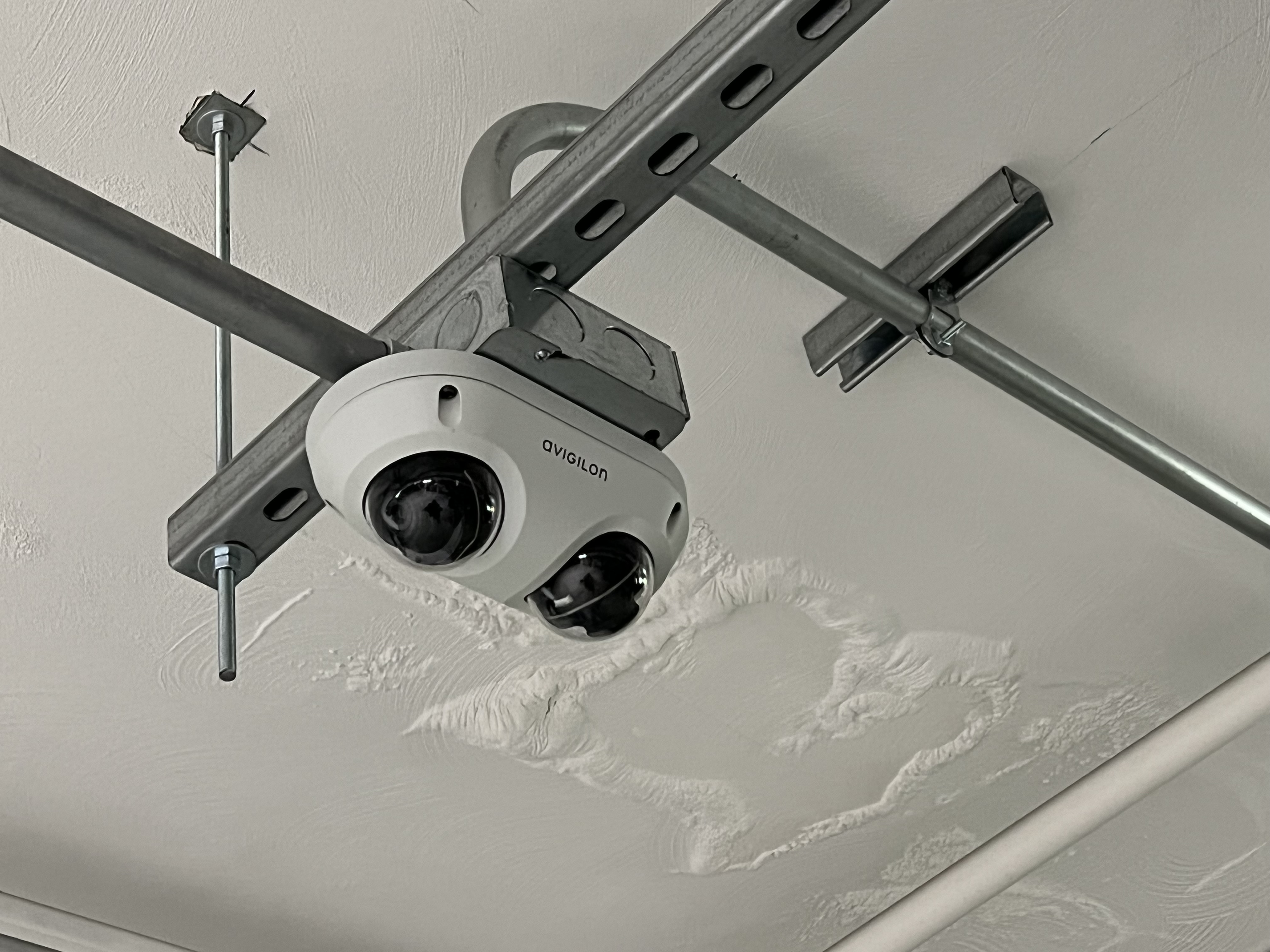 A camera system hangs from a ceiling.